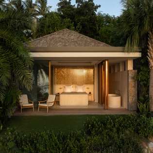 A luxurious spa pavilion nestled among tropical palms offers the perfect sanctuary for relaxation and rejuvenation.