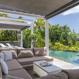 Sink into plush comfort and gaze at your private infinity pool framed by lush tropical palms—your perfect hideaway for quiet mornings or sun-soaked afternoons.