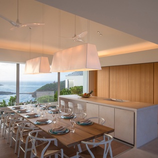 Breathtaking ocean views frame your gourmet meals in this stunning open-plan kitchen and dining space.