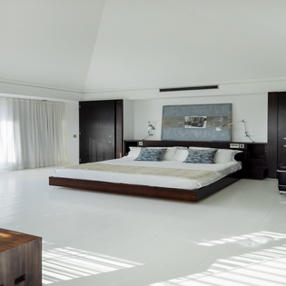 Unwind in your sleek, modern bedroom where minimalist design meets ultimate comfort—expansive windows flood the space with natural light.