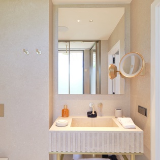 Step into your luxurious bathroom where warm marble tones and thoughtful details create your perfect morning ritual sanctuary.