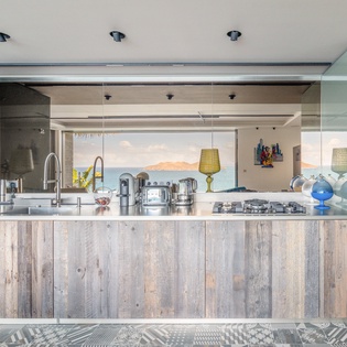 Sleek modern kitchen with stunning mountain views awaits your culinary adventures, featuring premium appliances and elegant finishes.