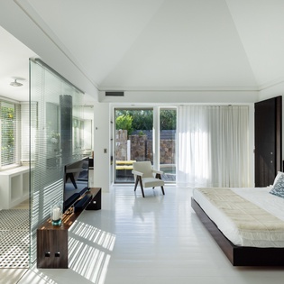 Unwind in your sophisticated suite where natural light streams through floor-to-ceiling windows, creating perfect relaxation vibes.