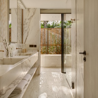 Luxurious marble bathroom with spa-like soaking tub and private outdoor courtyard for your ultimate relaxation retreat.