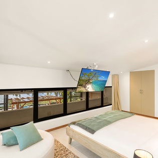 Relax in your sophisticated bedroom with modern furnishings and breathtaking views through floor-to-ceiling windows.