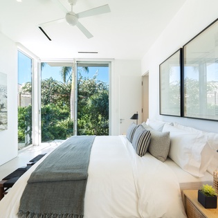 Wake up in your bright, tropical retreat with garden views framing your morning moments through floor-to-ceiling windows.