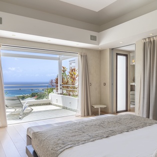 Wake up to breathtaking ocean views from your private terrace. Floor-to-ceiling glass doors flood your suite with natural light and frame the sparkling coastline beyond.