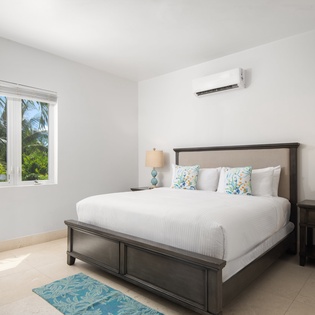 Drift off in this bright, airy bedroom where tropical breezes flow through your window and cool AC keeps you comfortable all night.