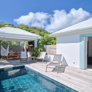 Your private pool oasis awaits with crystal-clear waters, relaxing loungers, and a hammock under your own pergola.