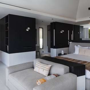 Your spacious suite blends modern luxury with comfort, featuring a plush king bed and cozy seating area for ultimate relaxation.