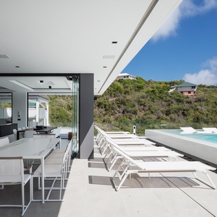 Relax on your private terrace with stunning pool views and open-air dining under tropical skies.