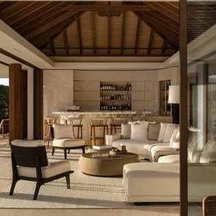 Unwind in your elegant living space where soaring wooden beams and plush seating create the perfect atmosphere for relaxation.