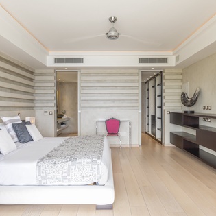 Step into your modern suite where soft lighting and crisp linens invite you to unwind after exploring the area. The sleek media center and elegant furnishings create your perfect haven for rest and relaxation.
