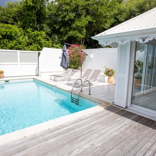 Your private oasis awaits with crystal-clear pool waters and sun loungers for ultimate relaxation on the spacious deck.