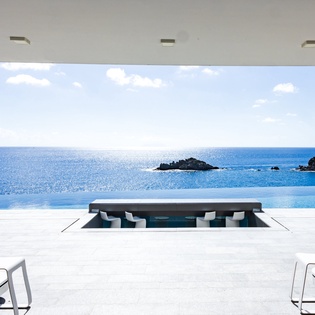 Sink into pure luxury in your infinity pool as endless ocean views and tropical islands create the perfect backdrop for relaxation.