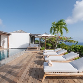 Stretch out on your private poolside deck under swaying palms, soaking up Caribbean sunshine with breathtaking ocean views all around.