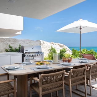 Dine al fresco at your private terrace with ocean views, complete BBQ kitchen, and elegant outdoor furniture for unforgettable seaside meals.