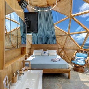 Soak in stunning coastal views from your unique geodesic dome retreat, where natural light floods through panoramic windows and a plush bed awaits beneath the sky.