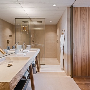 Luxurious spa-style bathroom with gleaming fixtures, fluffy robes, and elegant touches create your perfect retreat.