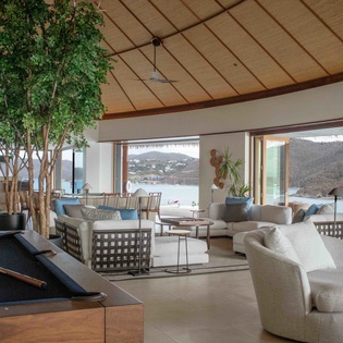 Unwind in your stunning living space with pool table entertainment, while panoramic windows frame breathtaking coastal views for unforgettable moments.
