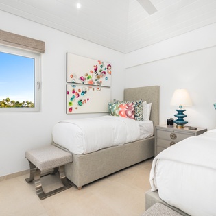 Rest peacefully in your bright twin bedroom with cheerful artwork and garden views through the window.