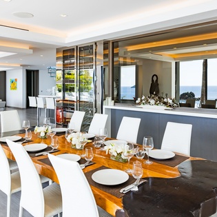 Gather around this stunning dining table where ocean views and elegant design create unforgettable dinner experiences.