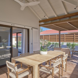 Relax on your private covered terrace with natural wood dining table and comfortable seating, perfect for enjoying morning coffee or evening meals.