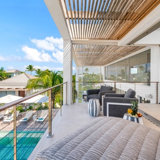 Your private terrace offers stunning pool views and comfortable seating under elegant wooden pergola, perfect for relaxing in tropical paradise.