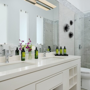 Step into your private spa-like bathroom with a spacious walk-in shower, sleek dual vanity, and fresh white linens waiting for you—elegant, calming, and designed for your comfort.