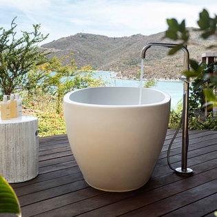 Soak in your private outdoor tub while gazing at stunning coastal mountains and turquoise waters.