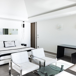 Unwind in your sleek sanctuary where crisp white linens and modern touches create the perfect retreat for relaxation.