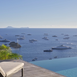 Spectacular sea views with distant islands from this infinity pool terrace overlooking yacht-filled waters.