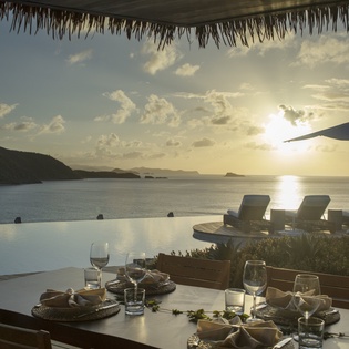 Stunning infinity pool terrace overlooking pristine ocean waters, where you'll dine as golden sunsets paint the tropical sky above your paradise retreat.