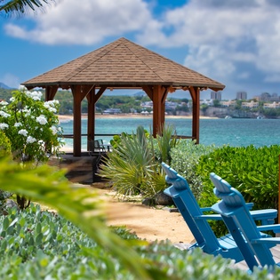 Oceanfront gazebo and lush tropical gardens frame stunning coastal views, offering a serene spot to unwind and soak in the island atmosphere.