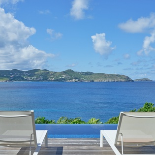 Relax in your private poolside chairs with stunning ocean views and tropical islands stretching endlessly before you.
