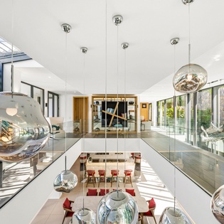 Step into your stunning open-plan sanctuary where modern design meets comfort, with soaring ceilings and artistic lighting creating an inspiring atmosphere.