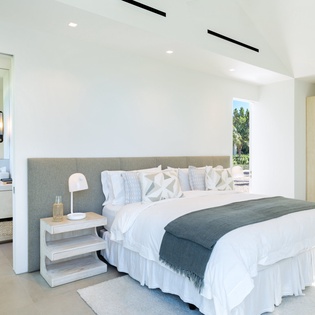 Unwind in your serene sanctuary with crisp linens, natural light streaming through expansive windows, and a spa-like ensuite beckoning relaxation.