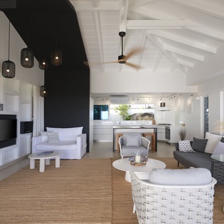 Settle into this stunning open-plan living space where modern elegance meets coastal charm, complete with stylish pendant lighting and seamless indoor-outdoor flow.