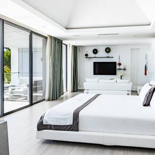 Wake up in this stunning oceanfront suite where floor-to-ceiling windows frame endless sea views from your plush king bed.