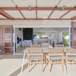 Dine al fresco under your private pergola, where modern design meets tropical comfort in this seamless indoor-outdoor living space.