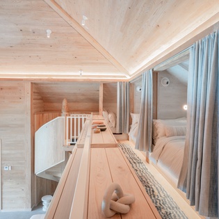 Cozy into your private pod with soft linens and warm wood surrounding you in this intimate dormitory-style retreat.