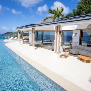 Stunning infinity pool and outdoor terrace with panoramic ocean views and luxury furnishings for the ultimate tropical escape.