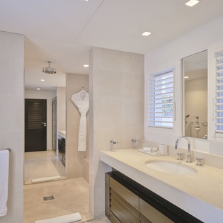 Luxurious spa-style bathroom featuring marble countertops, rainfall shower, and plush towels for your perfect morning routine.