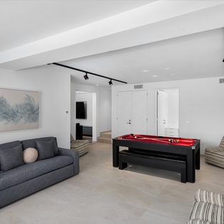 Your private game room awaits with a sleek pool table and cozy seating for unforgettable evenings with friends and family.
