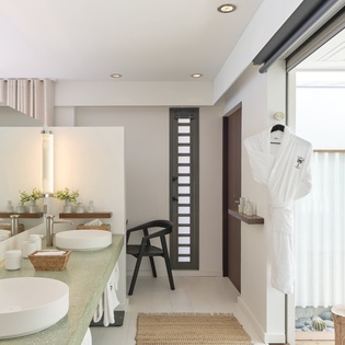 Step into your serene spa-like bathroom, where modern vessel sinks and warm wood accents invite you to unwind in style and comfort.