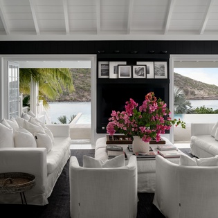Sink into plush white sofas while gazing at stunning ocean views through French doors that open to tropical paradise.