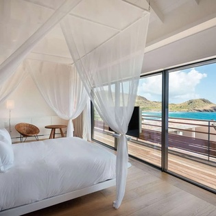 Drift off under soft canopy drapes while turquoise waves and rolling hills fill your view. Step onto your private terrace to feel the ocean breeze and start each morning in pure tranquility.
