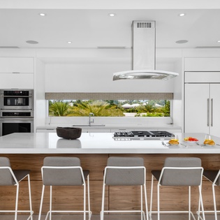 Your sleek modern kitchen features premium appliances and a spacious island where you'll love preparing meals with garden views.