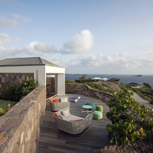 Modern oceanfront terrace with stunning sea views and contemporary outdoor furniture creates the perfect coastal retreat.
