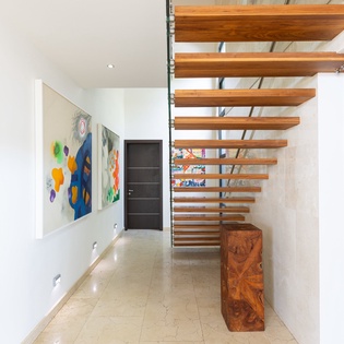 Step into this stunning modern entryway where artistic touches and sleek design create an elegant first impression for your stay.